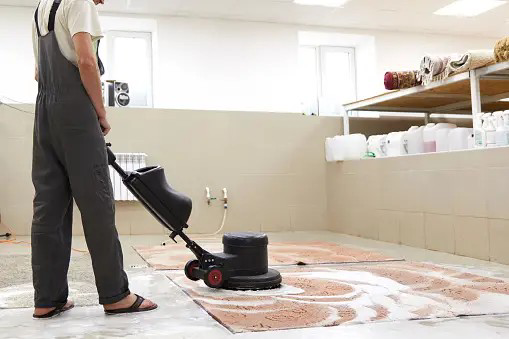 A man washing a carpet