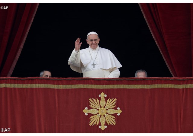 Pope Francis at the balcony of St Peter's Basilica, as he began his Christmas message ahead of the traditional Urbi et orbi Blessing.  - AP