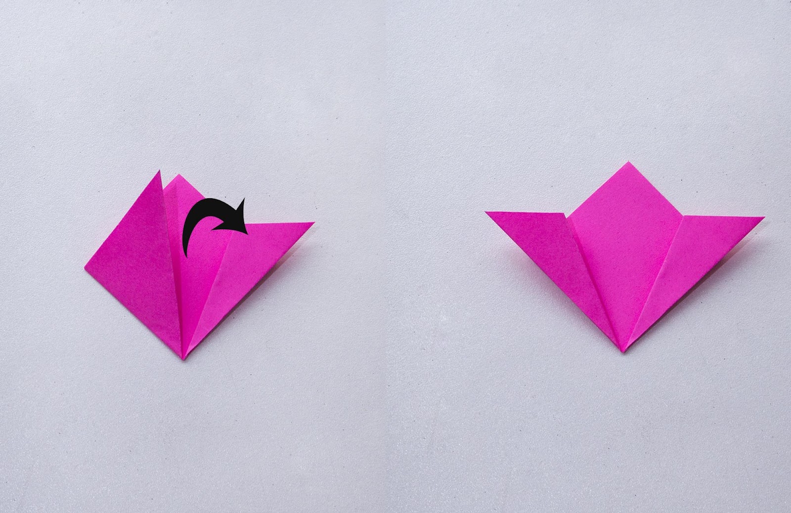 A sheet of pink  paper is being folded. A black arrow indicates which direction to fold