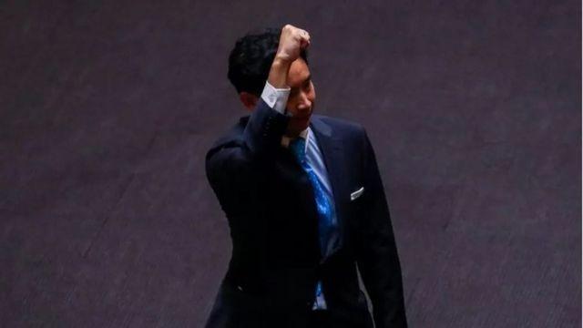 Pita Limjaroenrat, leader of the Move Forward Party gestures at parliament after Thailand"s Constitutional Court ordered his temporary suspension from the parliament, on the day of the second vote for a new prime minister, in Bangkok, Thailand, July 19, 2023.