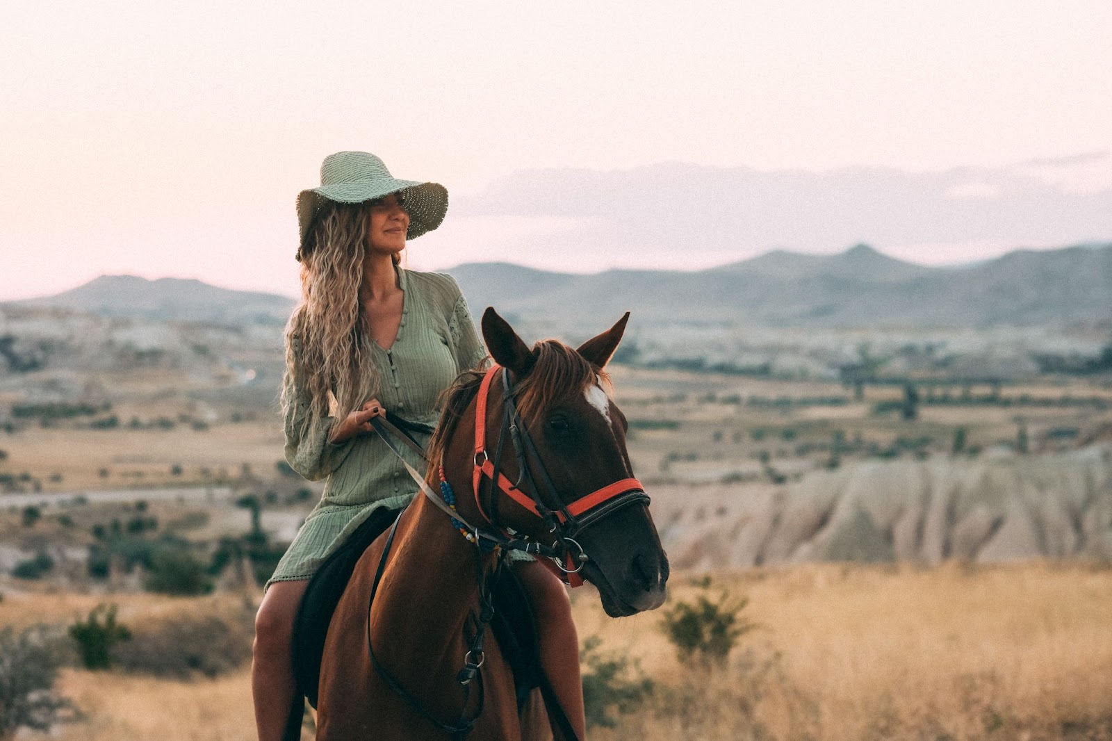 Women riding a brown horse