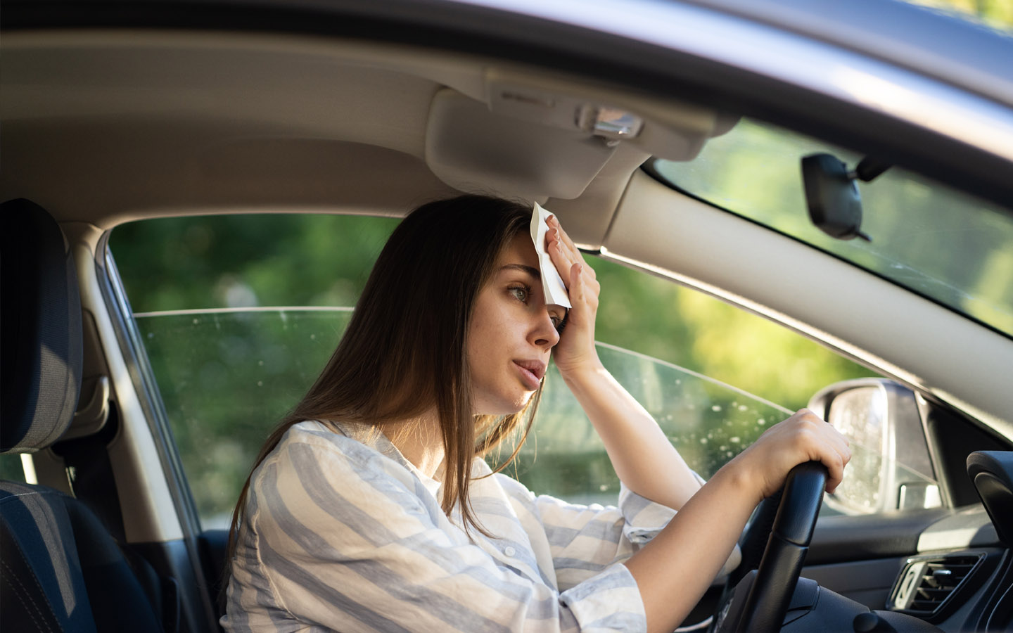 woman feeling warm in car