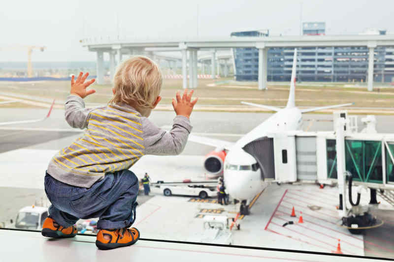 toddler looking at airplane