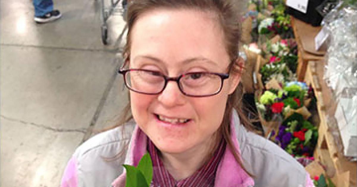 A person wearing glasses and smiling at the camera

Description automatically generated