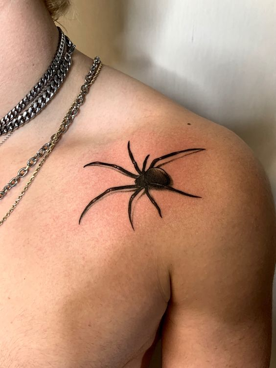 Another look of the spider tat on the shoulder of a guy