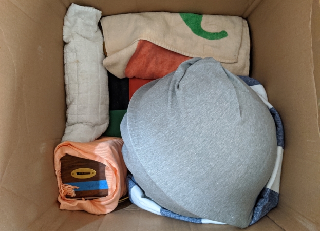 items wrapped in clothes and packed in a moving box