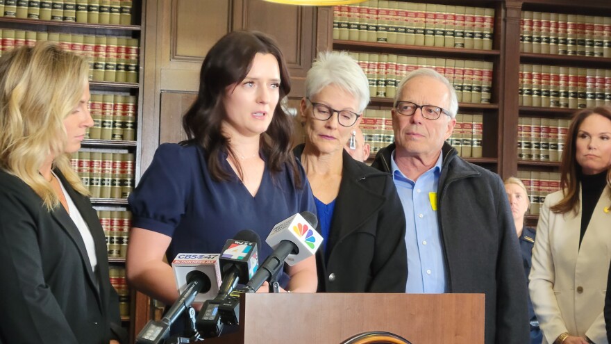 Jared Bridegan's widow, Kirsten Bridegan (center) speaks about the second arrest at a Thursday news conference, flanked by family in the State Attorney's Office.