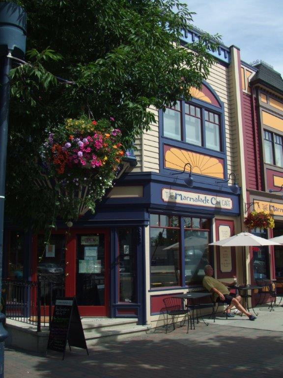 The exterior of the Marmalade Cat Cafe, with navy blue and burgundy trim on a Victorian style building