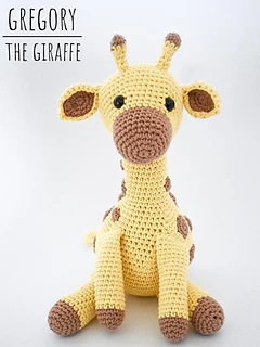 tall crochet giraffe amigurumi sitting up against white background