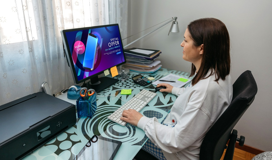 a woman checking an ad on her computer screen