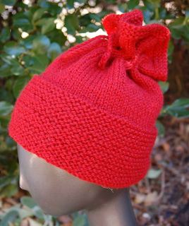 red messy bun hat on mannequin head outside