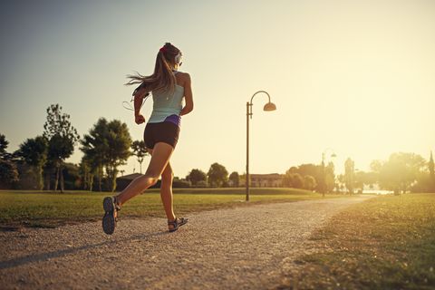 Teenage girl jogging in city park