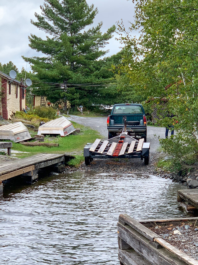 A large boat trailer backing into the water at Lady Evelyn Lake