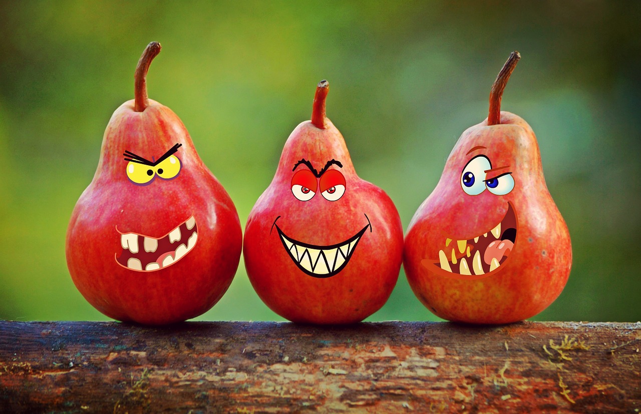 Three red pears with cartoon faces superimposed on them.
