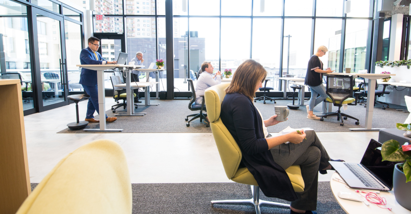 people working from individual desks in a shared coworking space in st. paul minnesota