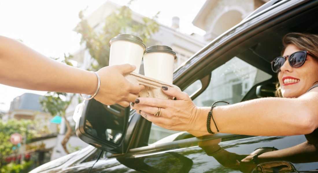 woman buying coffee in drive through