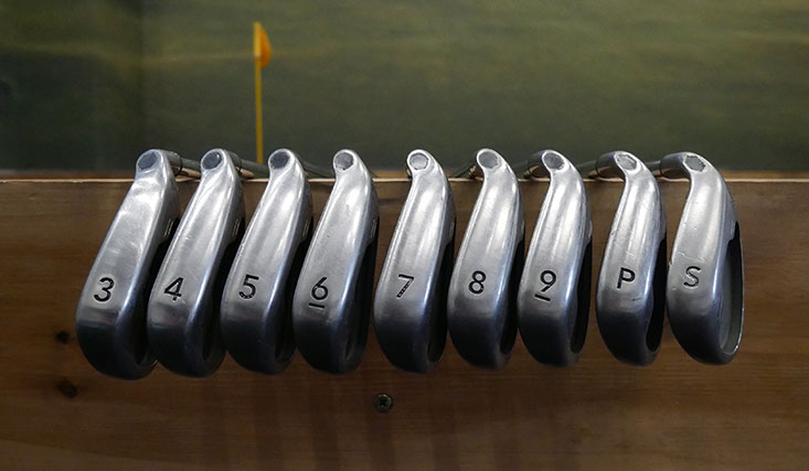 row of golf clubs