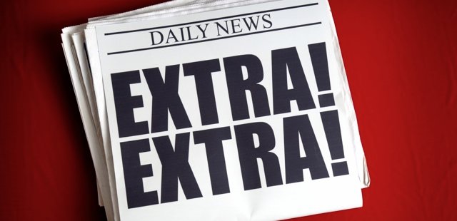 A photo of a newspaper that reads "Extra! Extra!" as the headline. 
