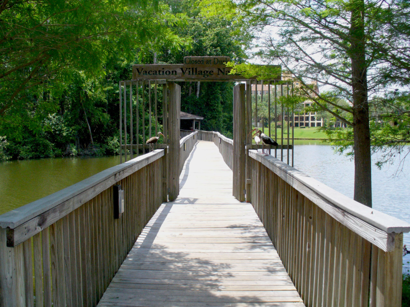 Vacation Village sign over a bridge