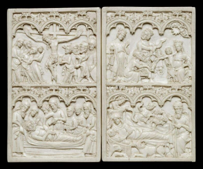 A highly decorative writing tablet made out of ivory with scenes from the Life of Christ, laid flat with both covers in view.
