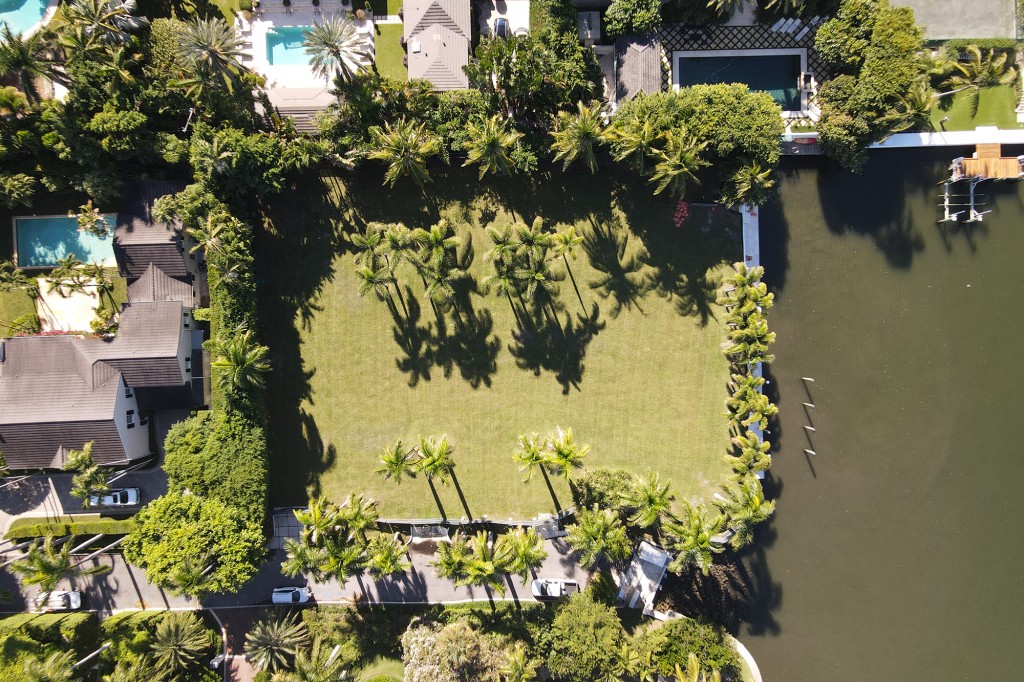 These exclusive aerial images show the so called 'House of Horrors' which once stood on the idyllic waterfront plot in Florida has vanished and in its place is a perfectly manicured lawn. 