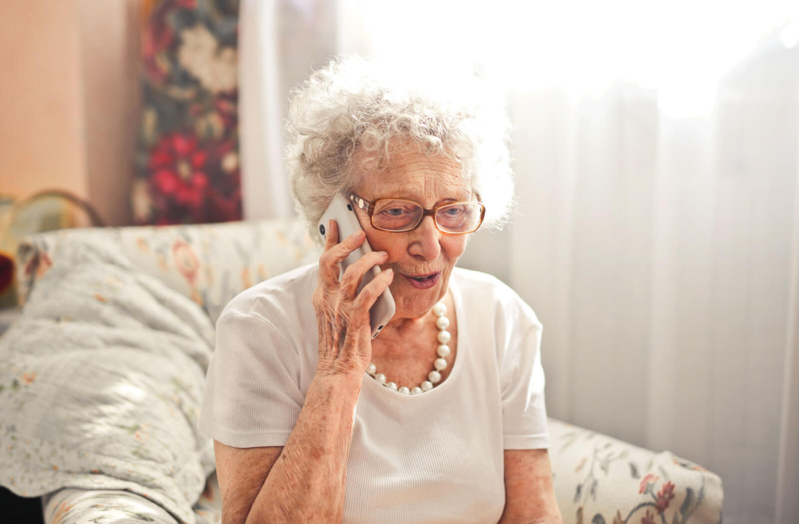 a woman with dementia talks on the phone
