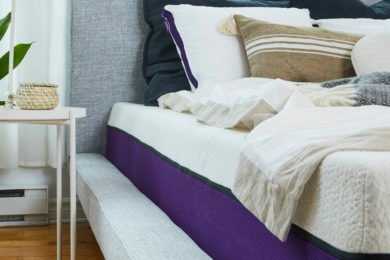 The Polysleep Mattress with pillows and blankets on top.