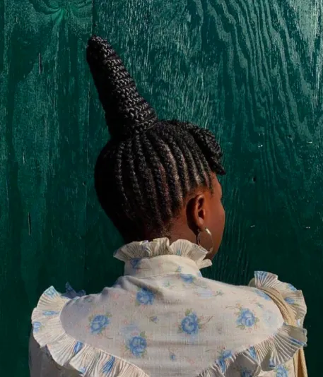 Black woman with a plaited up-do hairstyle