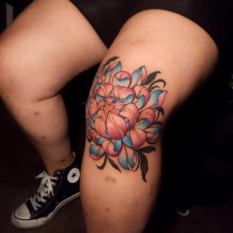 Guy show off his stylish flower knee cap tattoo