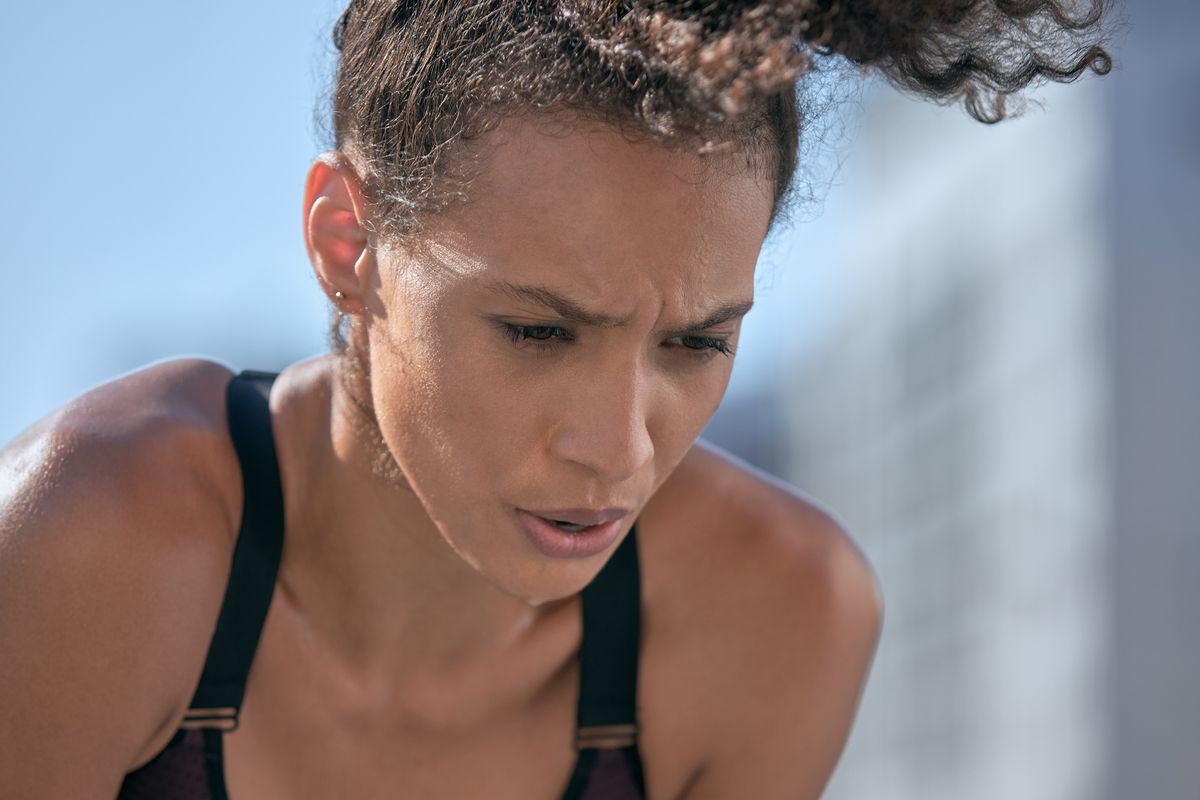 woman in sports bra breathing heavily