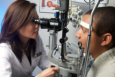 Eye doctor examining a patients vision Eye doctor examining a patients vision