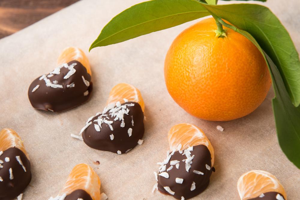 Served chocolate-dipped tangerine slices with coconut