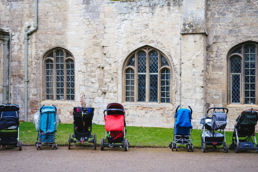 seven assorted-colored strollers near building