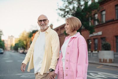 An elderly couple walking and exploring the town.