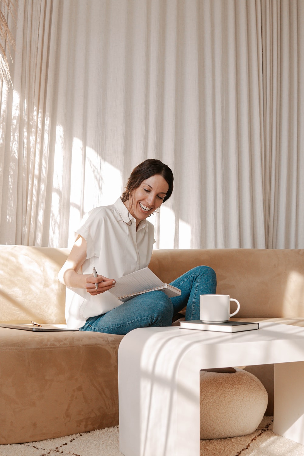woman in white long sleeve shirt sitting on bed