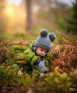 Toddler playing outside in the fall