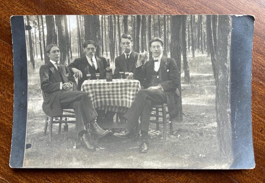 A group of men sitting at a table

Description automatically generated
