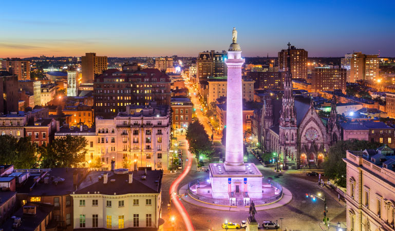 A nighttime aerial view of the original Washington Monument in the downtown Mount Vernon area outside of Baltimore.