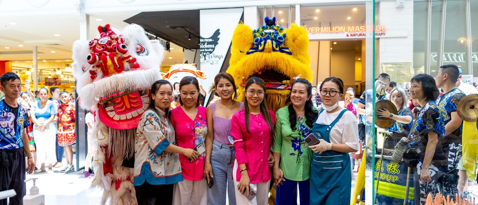 Forest Lake celebrates Year of the Rabbit. Retailers pose with traditional dragon dancers.