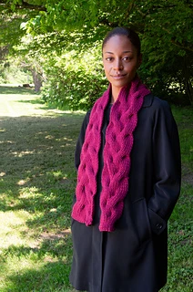 woman wearing a wide cable stitch scarf outside
