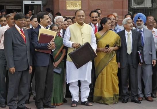 Finance Minister Arun Jaitley (C) poses as he leaves his office to present the federal budget for the 2014-15 fiscal year, in New Delhi July 10, 2014. REUTERS-Stringer