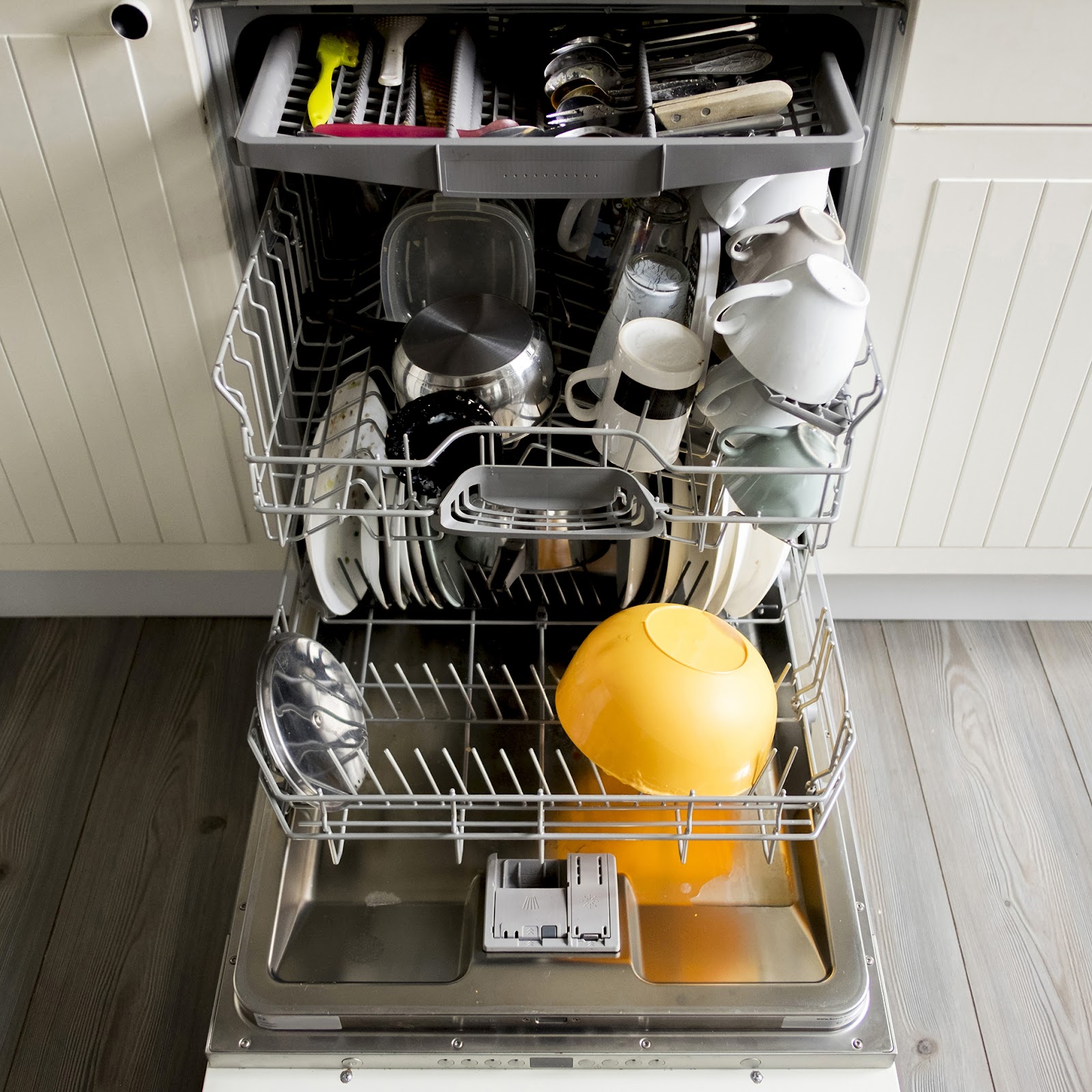 High angle view of dishes and utensils in dishwasher