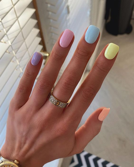 A gorgeous picture of a beautiful  hands polished with pastel hues 