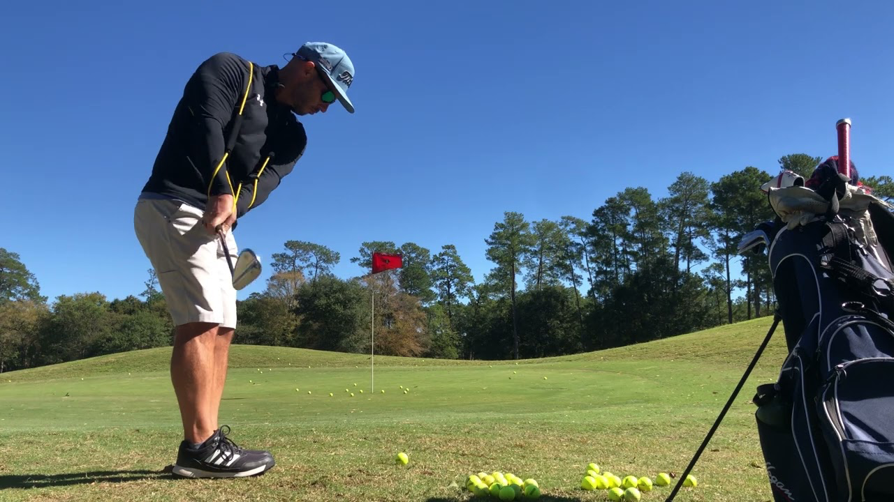 golfer practicing with 4 iron