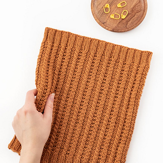 orange knit cowl flat on white background