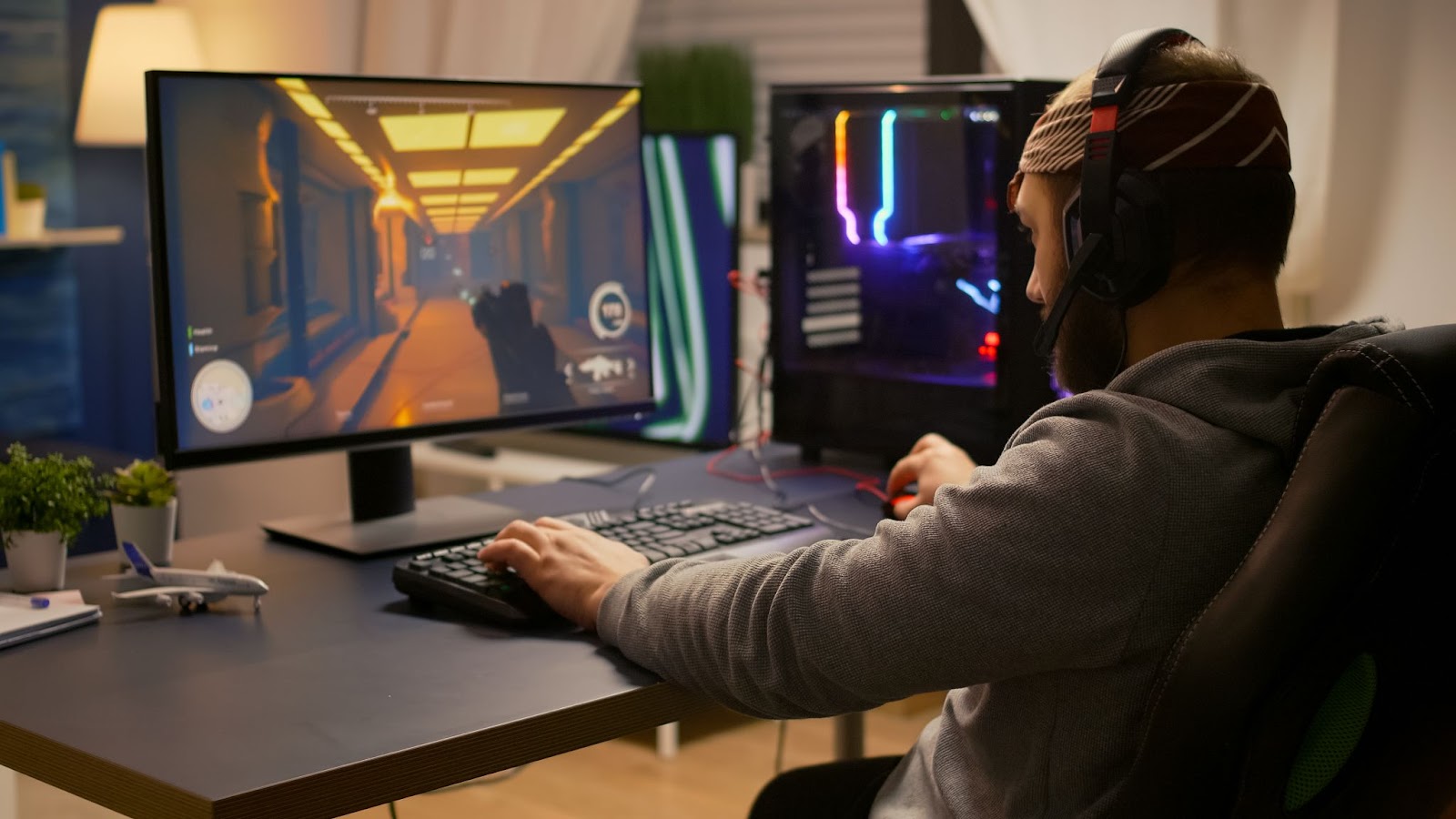 PC Gaming. Player sitting at a desk playing an FPS game
