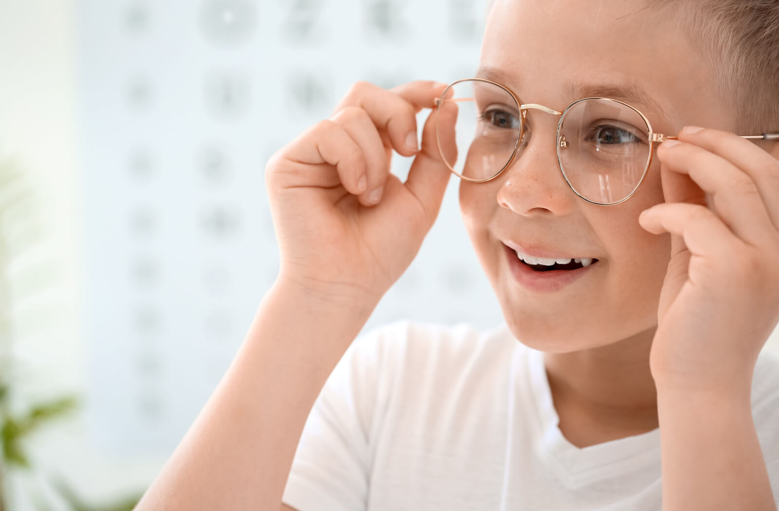 A young boy with myopia gets his corrective eyeglasses.
