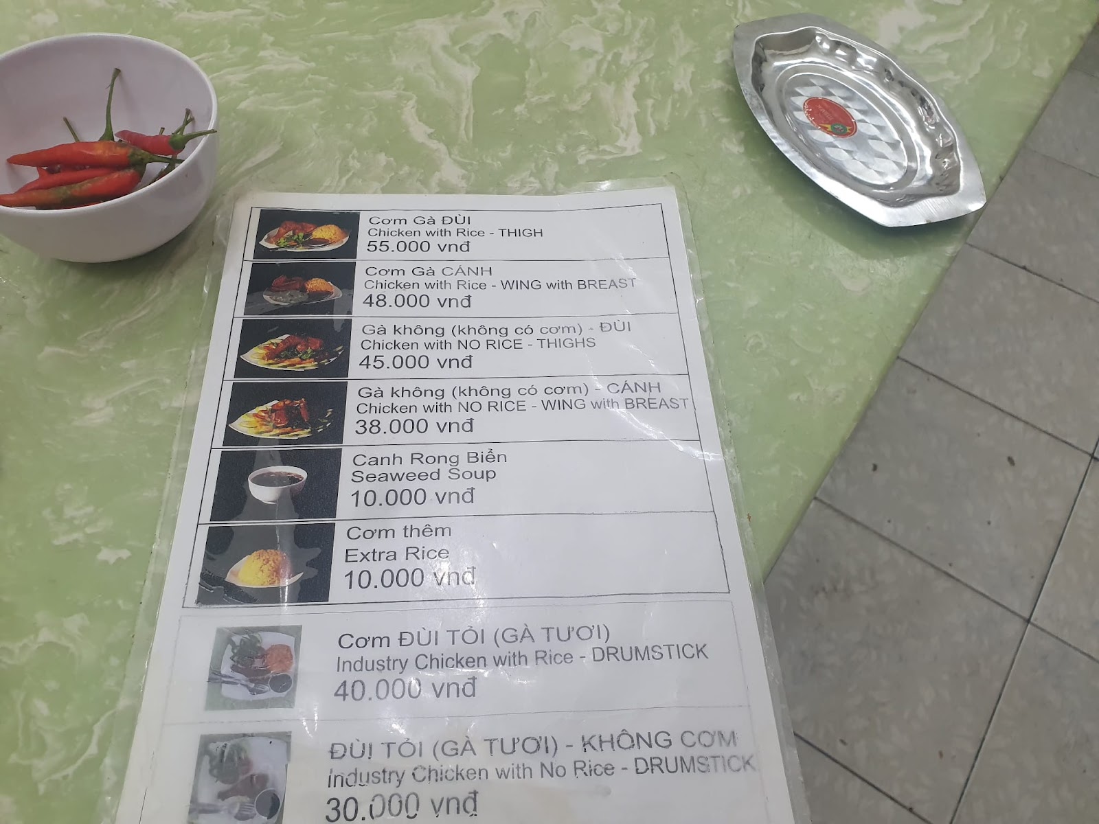 Cơm Gà Xối Mỡ Su Su menu with a bowl of chilisn