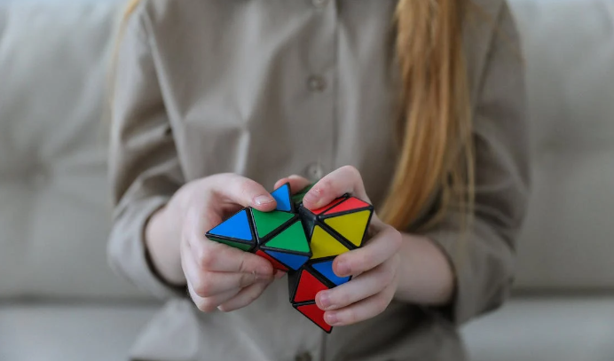 A girl is solving a puzzle