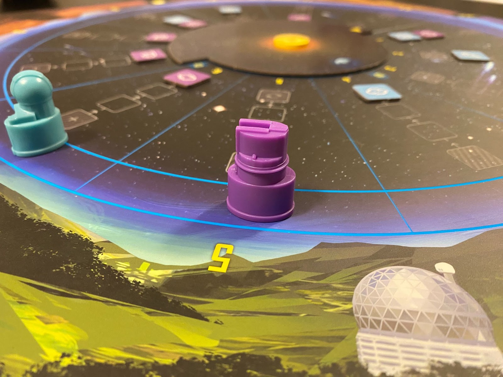 Picture of "Search for Planet X" game board - two plastic telescope token going around a circle.